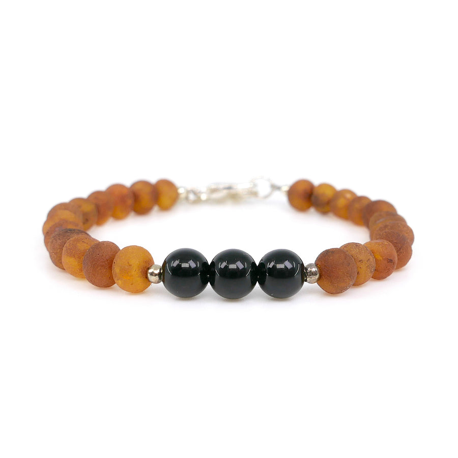 Pulsera ajustable para niño con ámbar en bruto color caramelo y cuentas de ónice