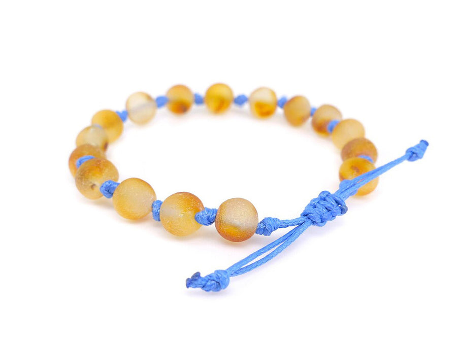 Pulsera tobillera calmante para bebés hecha de ámbar crudo y cordón azul