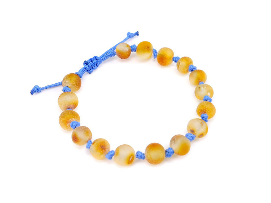 Accesorio de dentición con ámbar miel y diseño ajustable en cordón azul