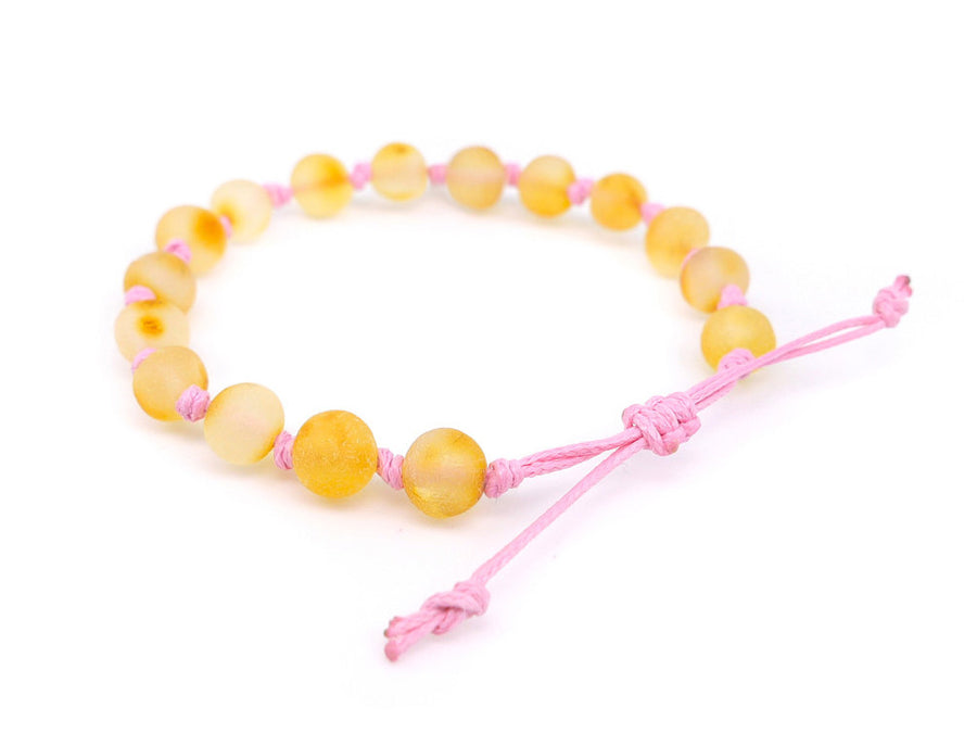 Pulsera natural de dentición para bebé con ámbar miel y cordón rosa
