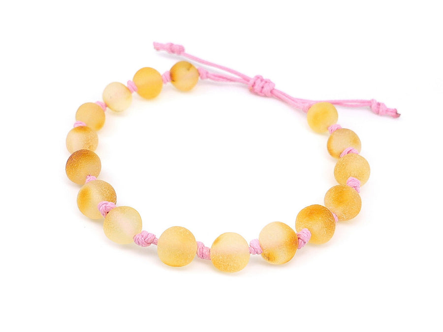 Pulsera ajustable de ámbar miel crudo con cordón rosa para bebés