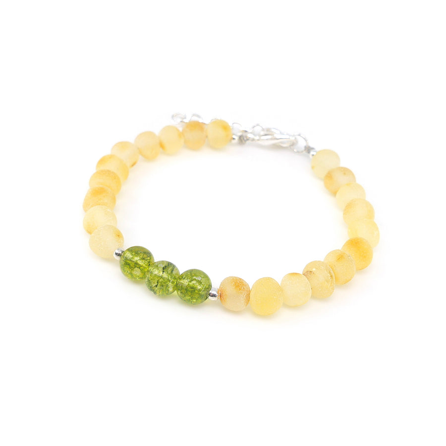 Pulsera artesanal con peridoto verde y ámbar en bruto, inspirada en el zodiaco